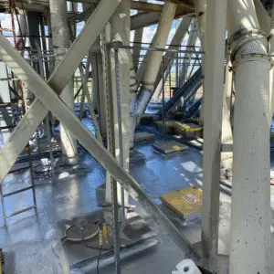 Industrial rooftop or flooring surface coated with a high-performance polymer protective coating