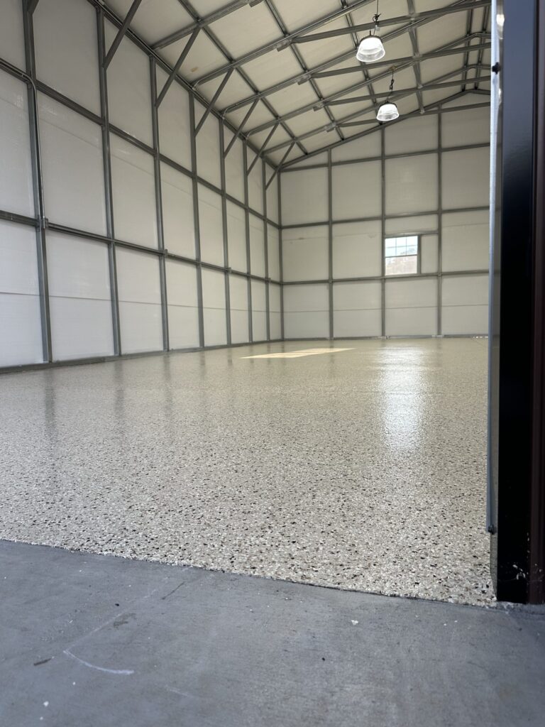 Metal building interior with a glossy light flake floor coating
